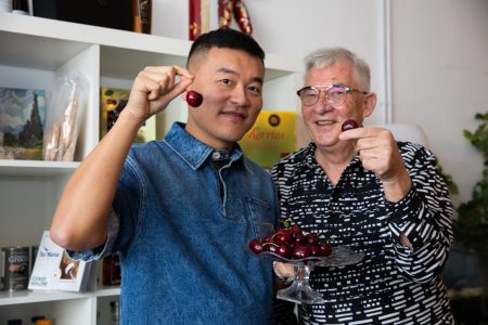 Calvin Yuen, and David Meredith holding cherries for photo