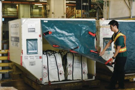 Ground staff sealing ULD with fire containment bags