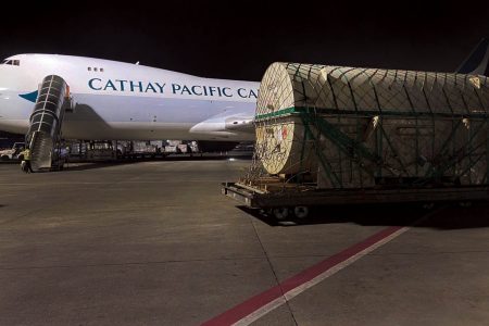 Heavyweight shipment on tarmac in front of Cathay aircraft
